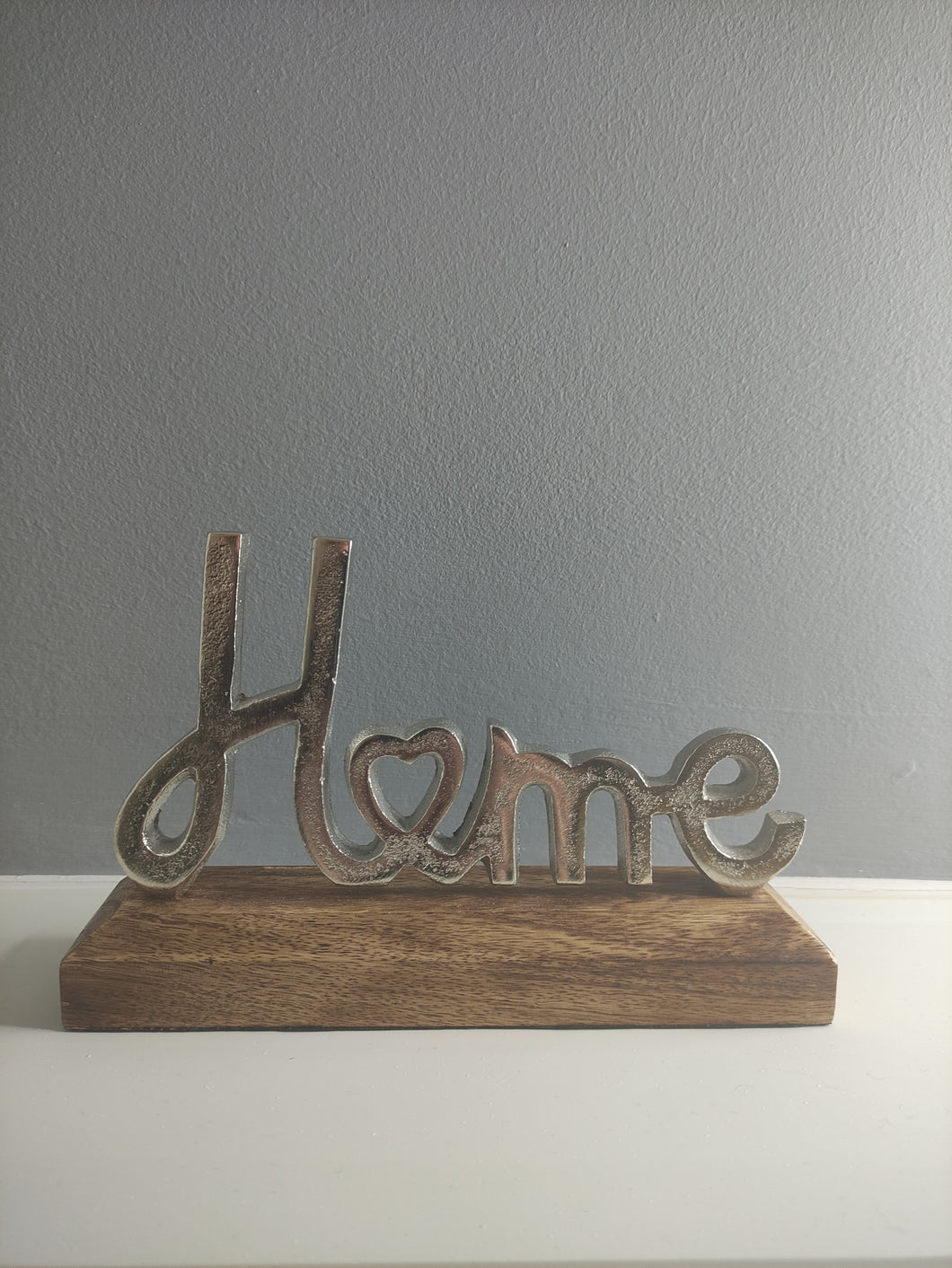 Silver metal Home sign on wooden base